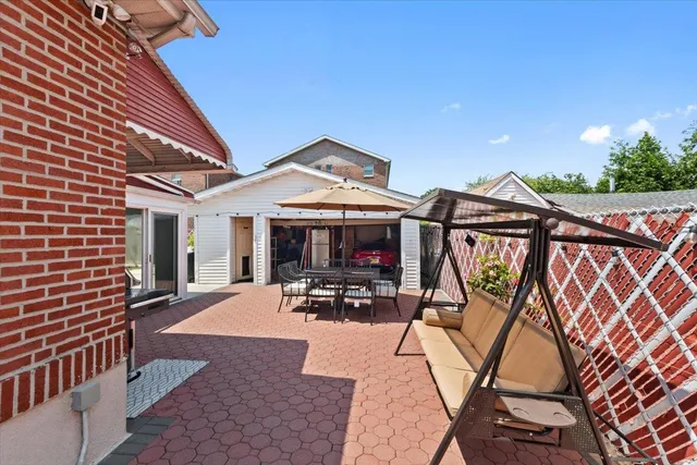 a view of a patio with table and chairs with wooden floor and fence