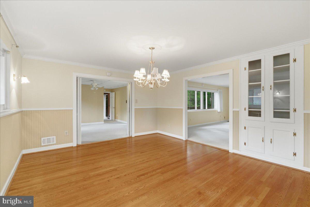 18309 Cabin Road Triangle, VA 22172 - Photo 13 of 42 a view of an empty room with wooden floor and a kitchen