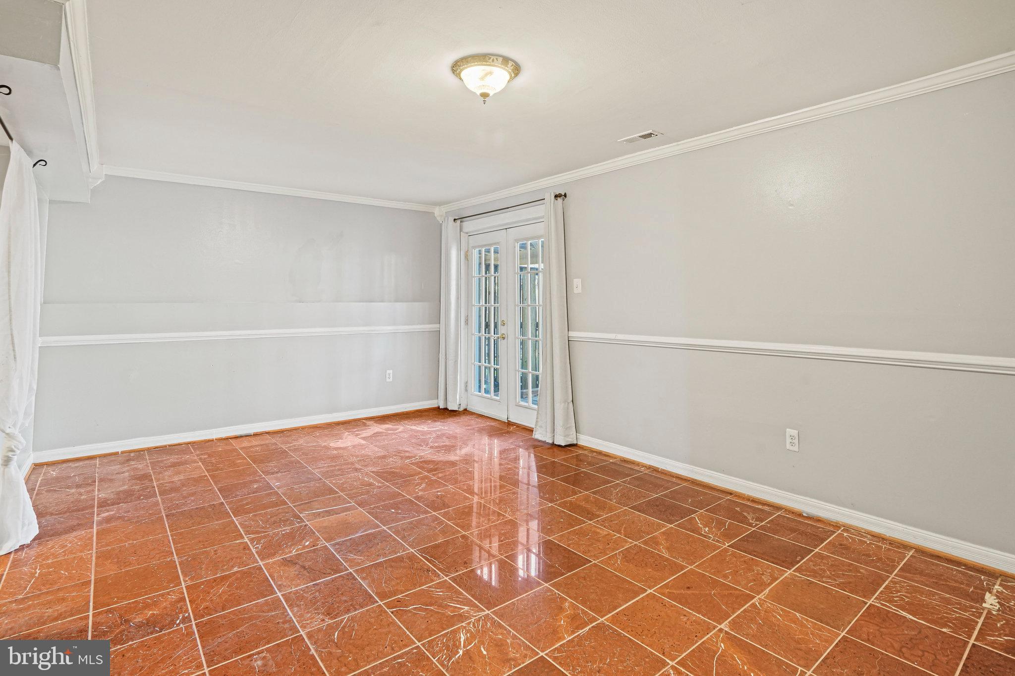 14902 Ashford Place Laurel, MD 20707 - Photo 11 of 41 a view of an empty room with wooden floor and a window
