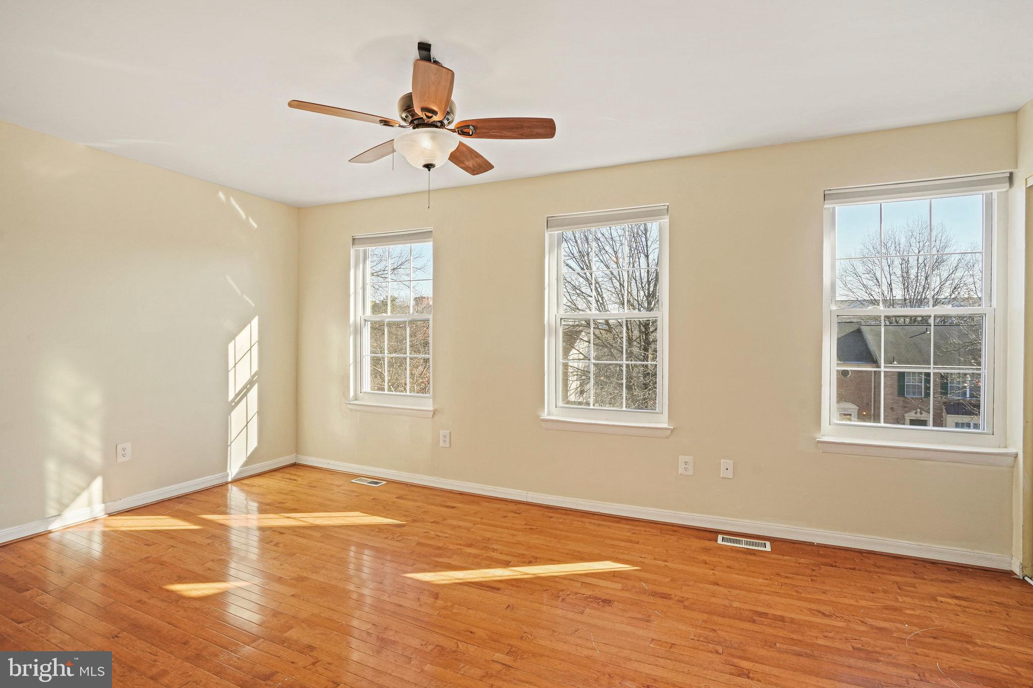 14902 Ashford Place Laurel, MD 20707 - Photo 25 of 41 a view of an empty room with wooden floor and a window