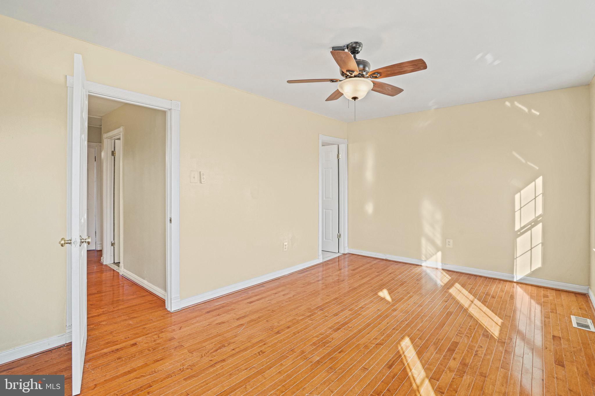 14902 Ashford Place Laurel, MD 20707 - Photo 27 of 41 a view of a livingroom with a ceiling fan and wooden floor