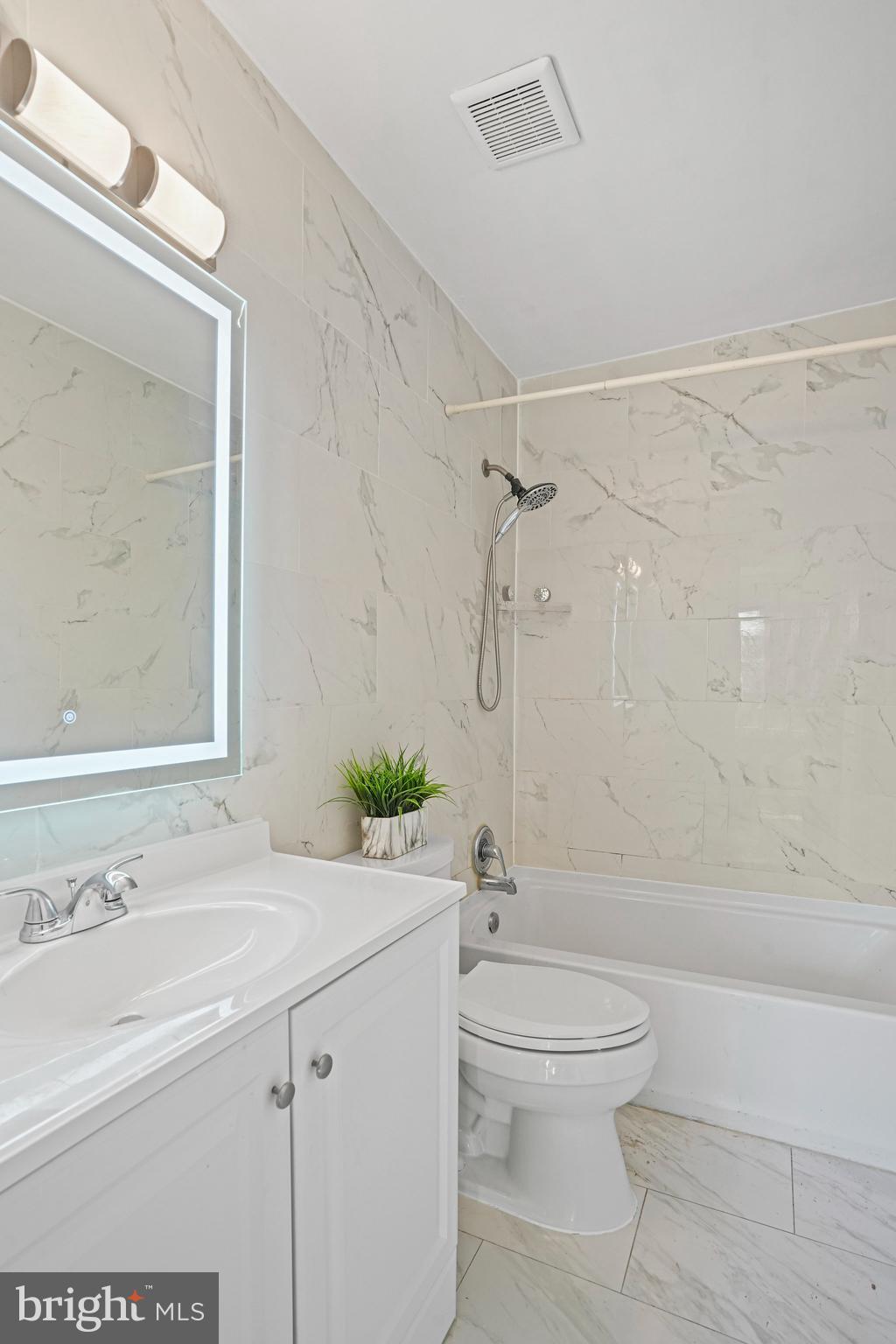 14902 Ashford Place Laurel, MD 20707 - Photo 29 of 41 a bathroom with a sink a toilet and shower