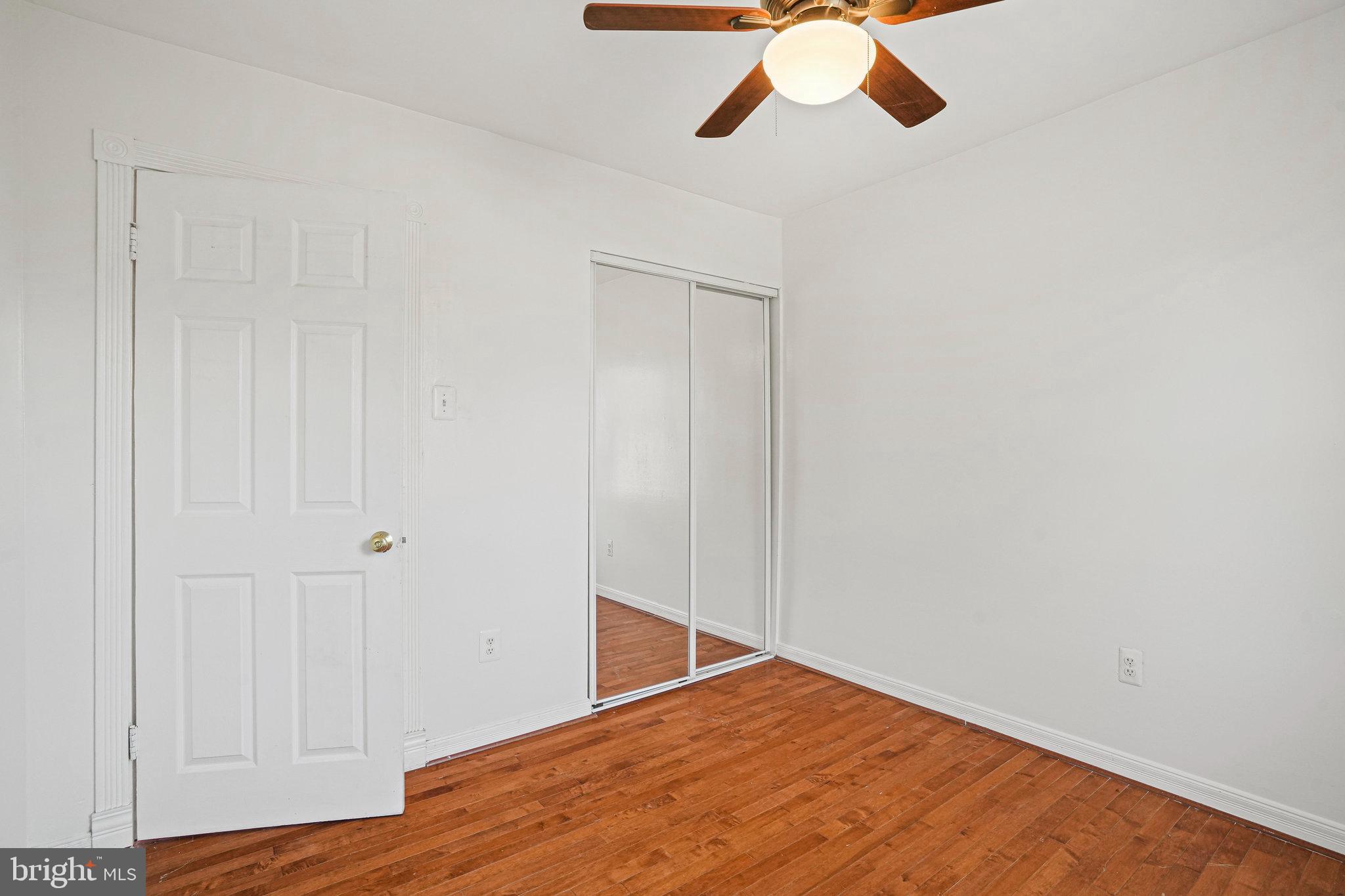14902 Ashford Place Laurel, MD 20707 - Photo 35 of 41 a view of empty room with wooden floor