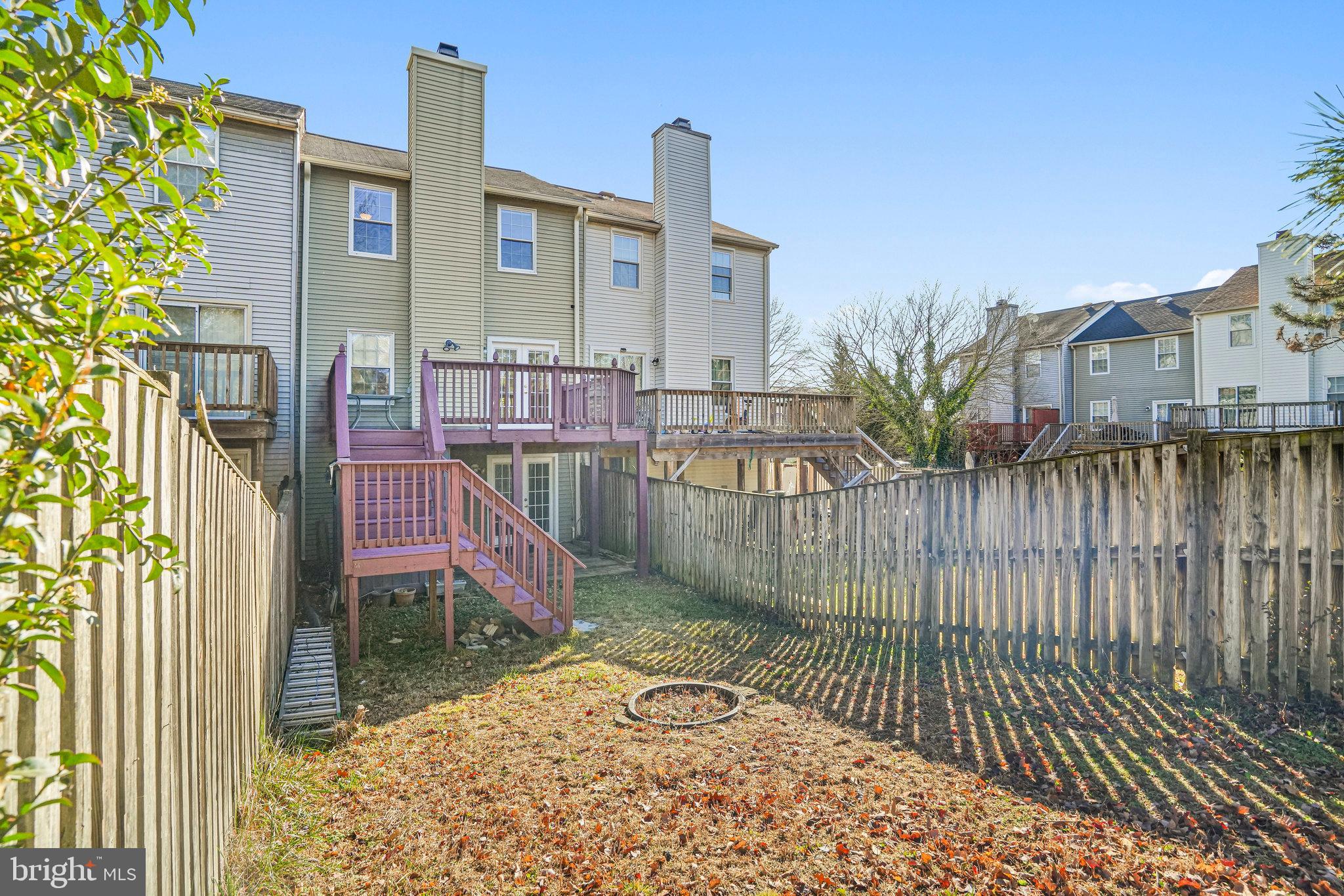 14902 Ashford Place Laurel, MD 20707 - Photo 41 of 41 a view of a brick house with large windows and a table and chairs
