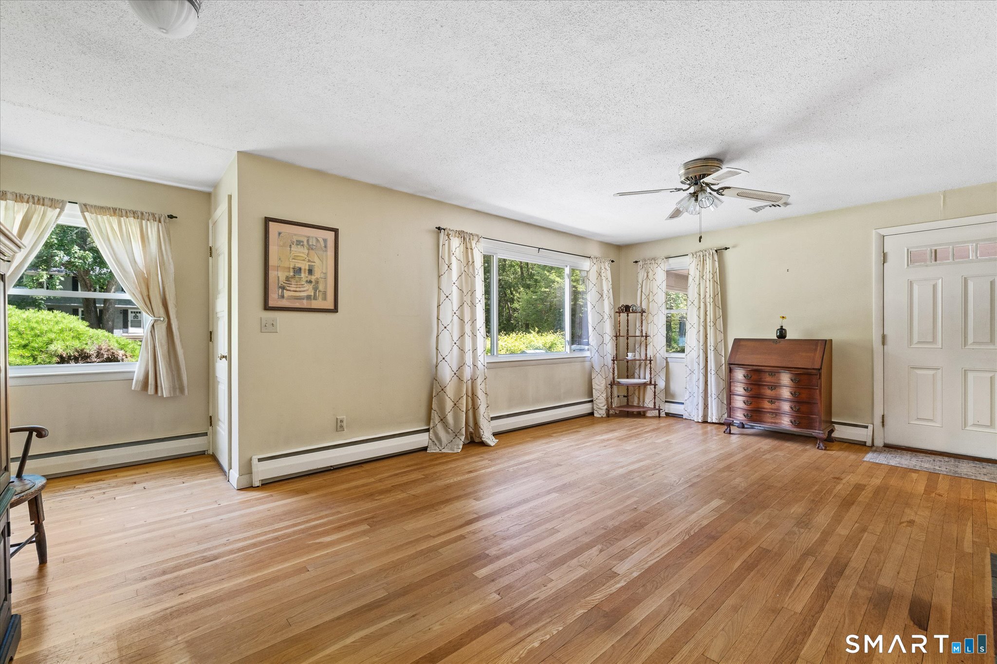 19 Beckwith Street Killingly, CT 06239 - Photo 11 of 39 a view of a livingroom with wooden floor and a ceiling fan