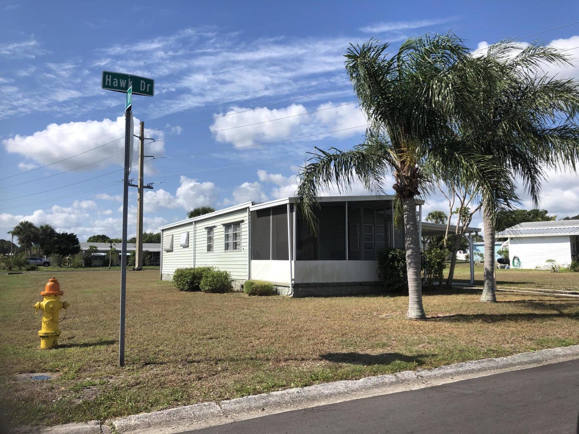 401 Hawk Drive Sebastian, FL 32976 - Photo 1 of 23 a front view of a house with a garden and yard