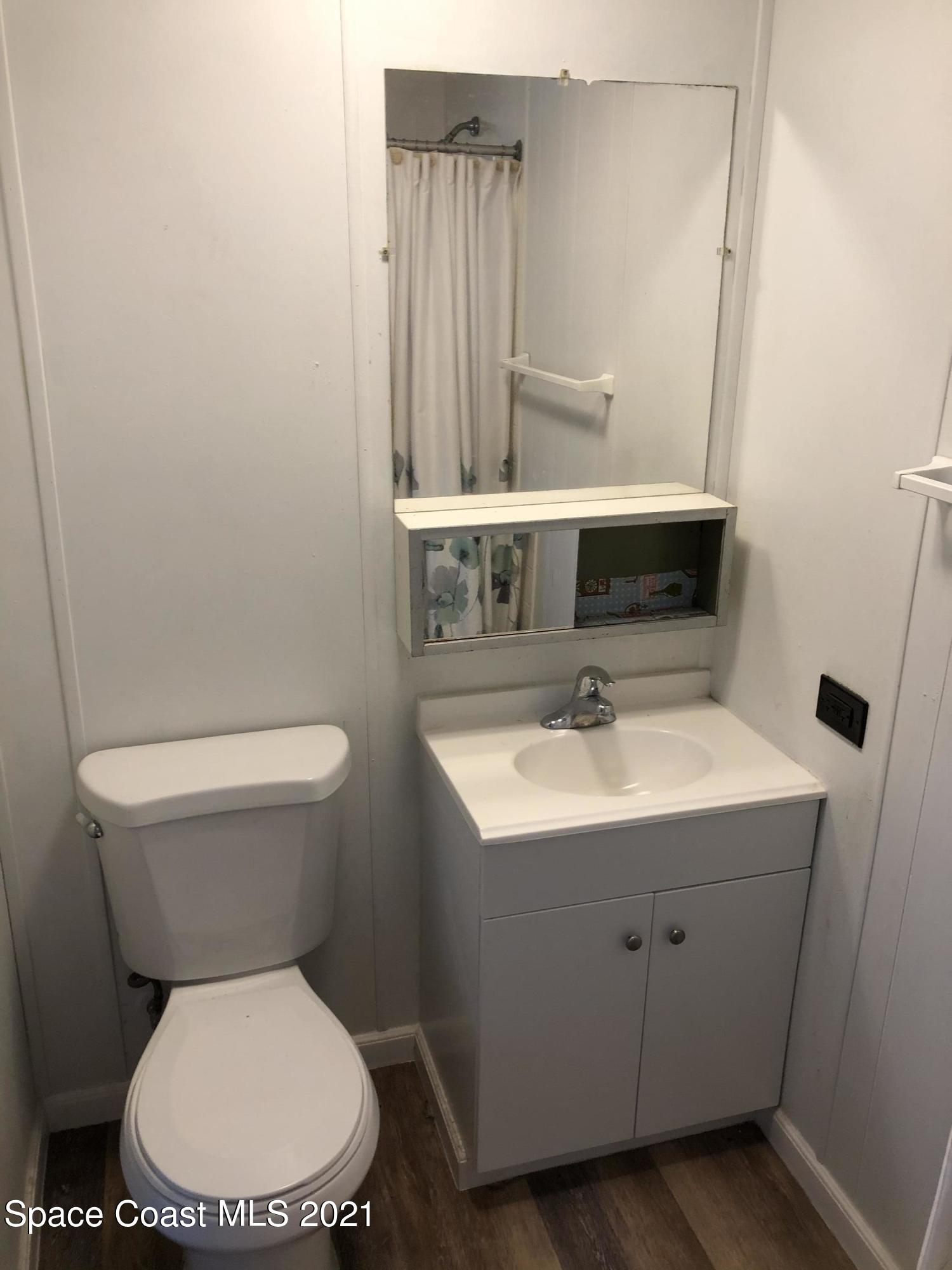 401 Hawk Drive Sebastian, FL 32976 - Photo 13 of 23 a bathroom with a toilet sink and mirror