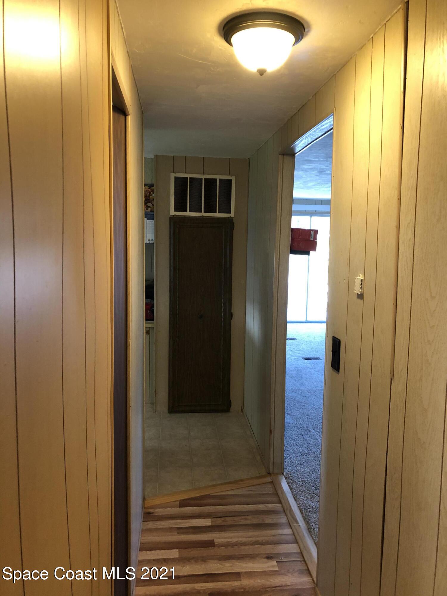 401 Hawk Drive Sebastian, FL 32976 - Photo 18 of 23 a view of a hallway with wooden floor and windows