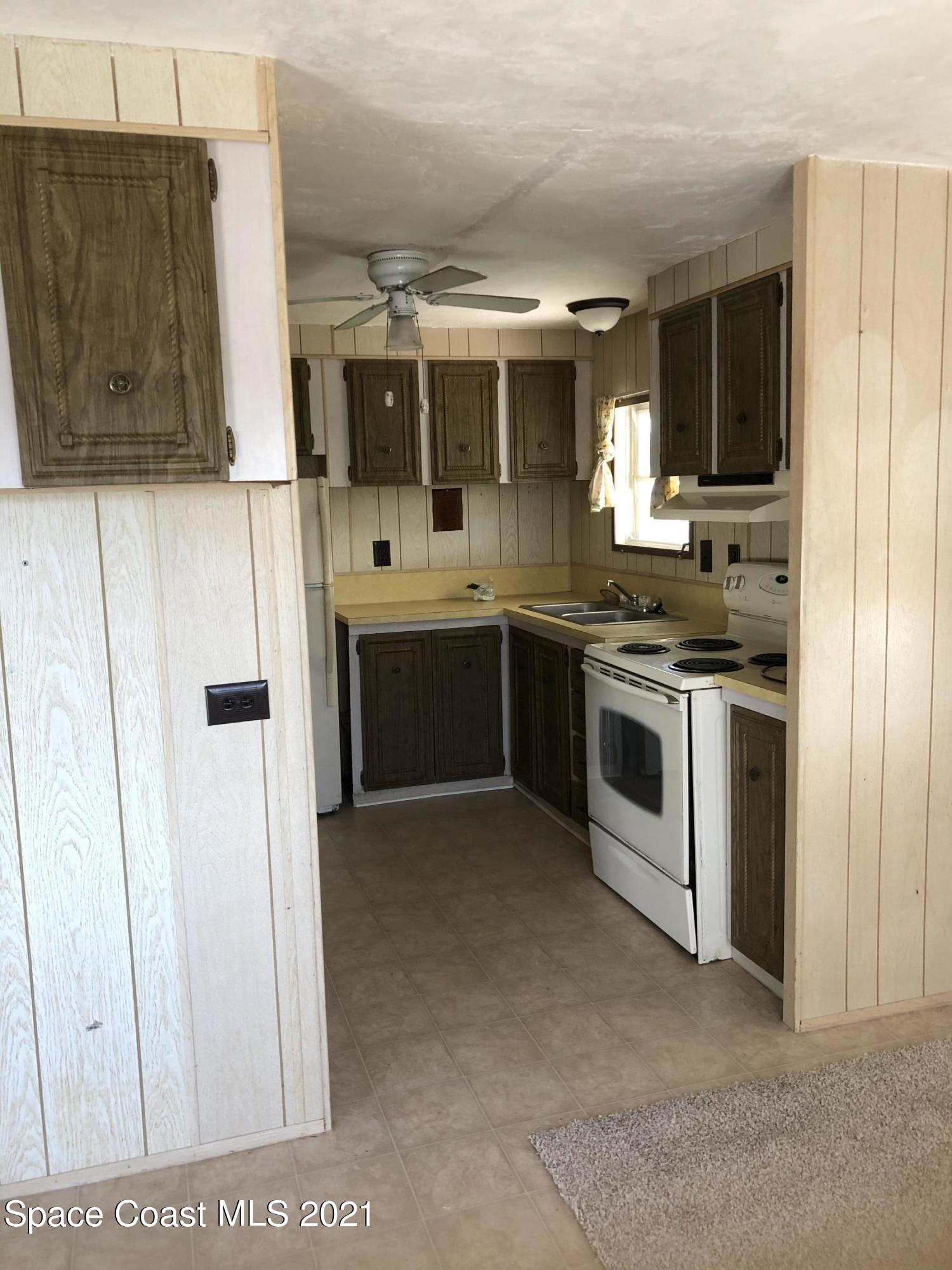 401 Hawk Drive Sebastian, FL 32976 - Photo 5 of 23 a kitchen with stainless steel appliances granite countertop a stove and a refrigerator