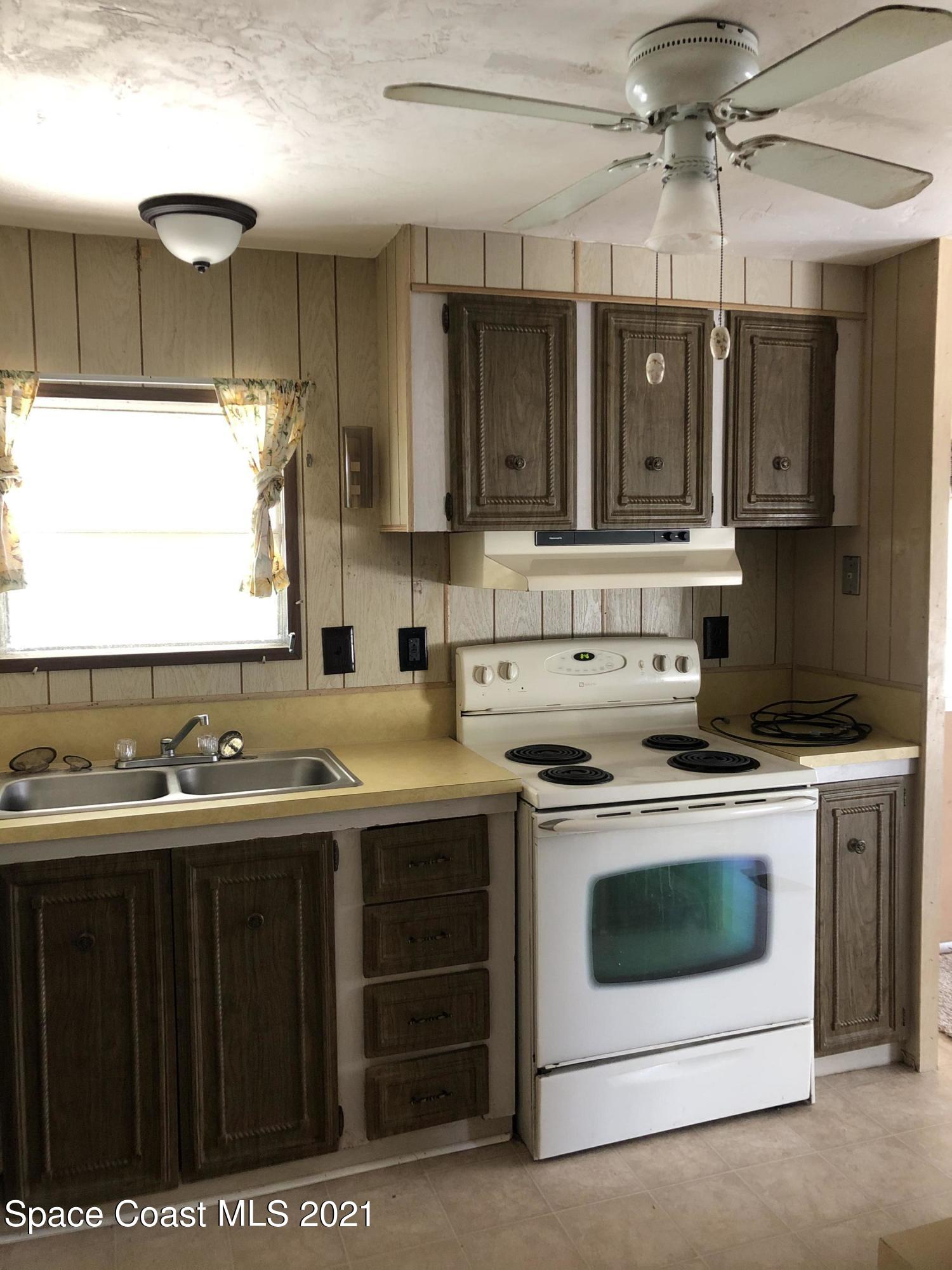 401 Hawk Drive Sebastian, FL 32976 - Photo 7 of 23 a kitchen with a stove and a sink