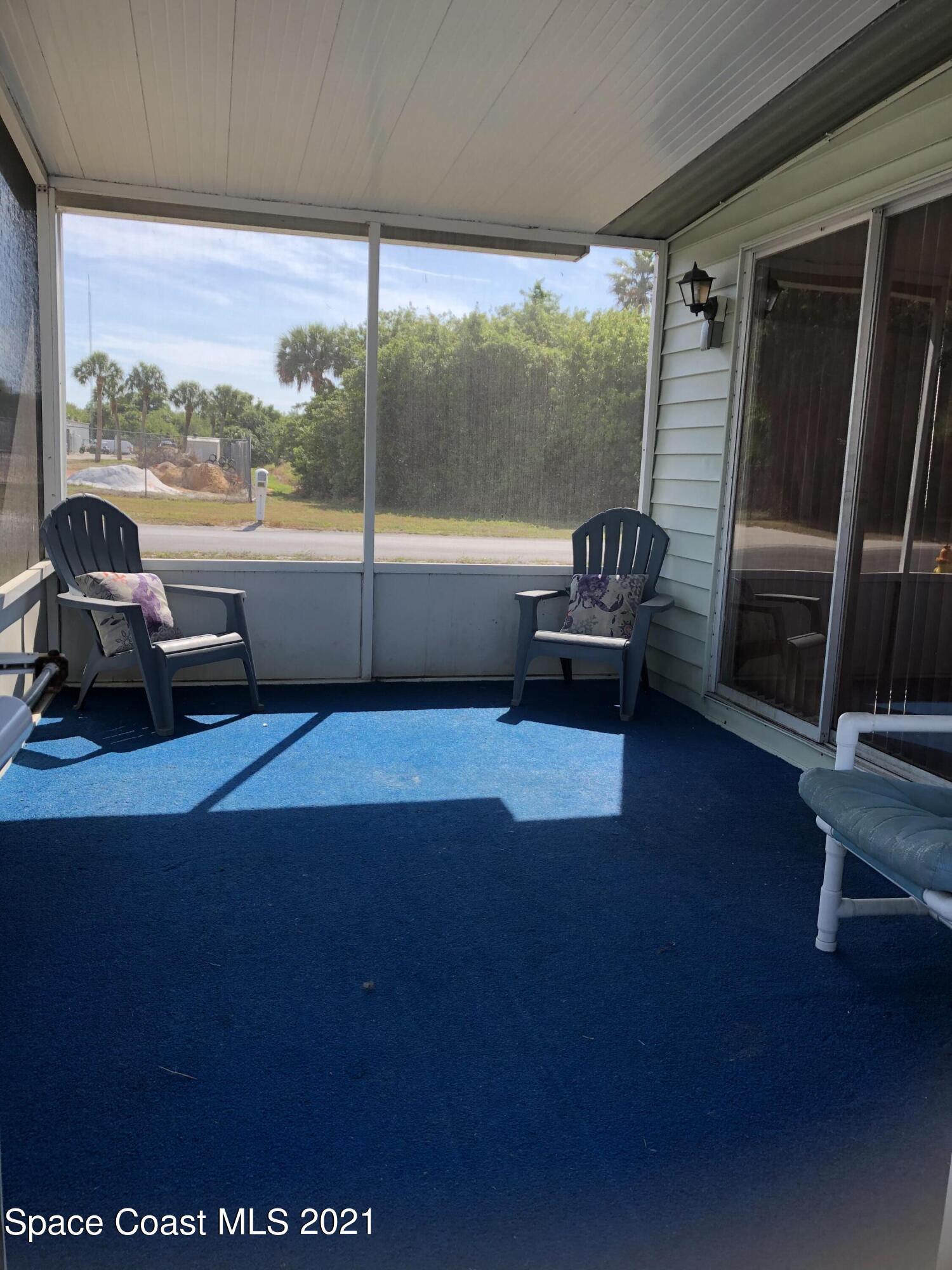 401 Hawk Drive Sebastian, FL 32976 - Photo 8 of 23 a living room with furniture and a floor to ceiling window