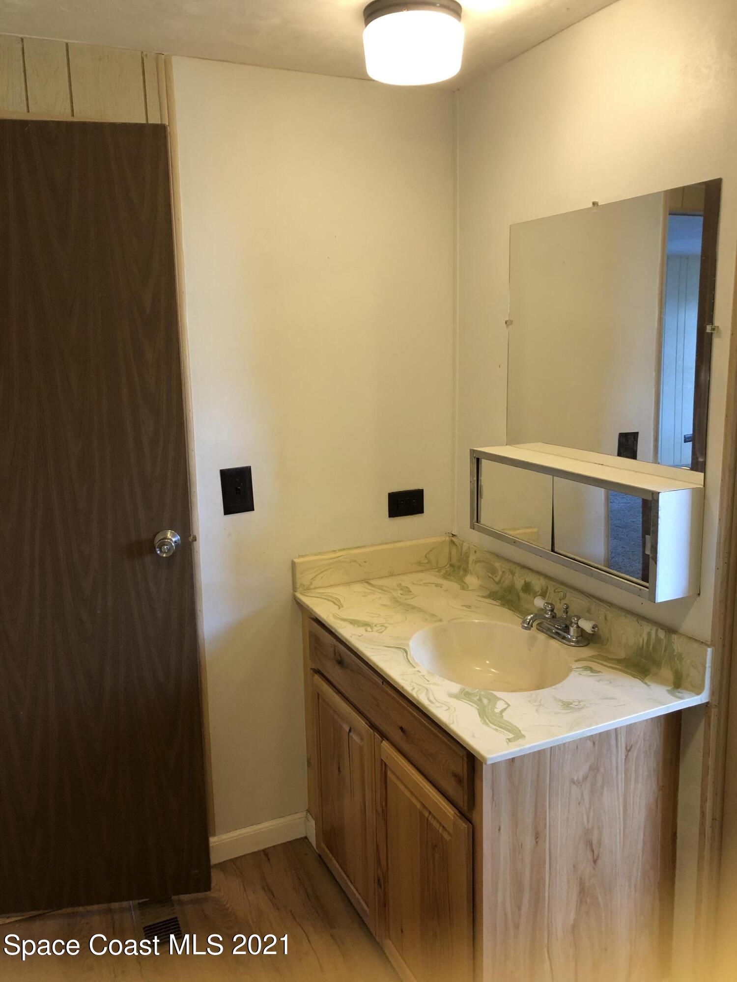 401 Hawk Drive Sebastian, FL 32976 - Photo 9 of 23 a bathroom with a sink and a mirror