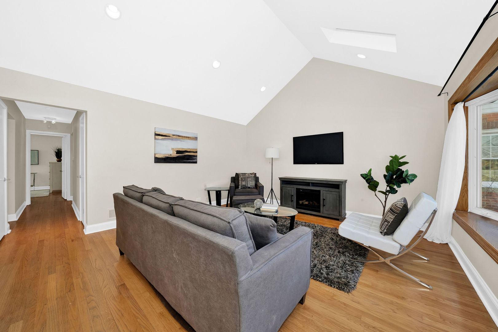 617 South Western Avenue Park Ridge, IL 60068 - Photo 5 of 40 a living room with furniture a flat screen tv and a fireplace
