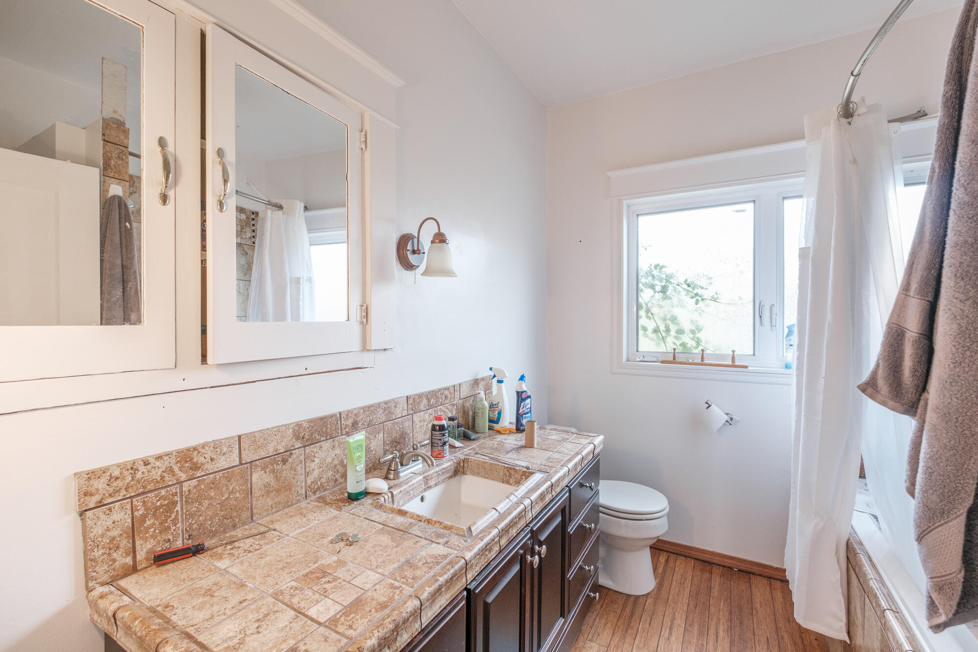 55 Q Street Cottage Grove, OR 97424 - Photo 35 of 36 a bathroom with a granite countertop sink toilet a mirror and shower