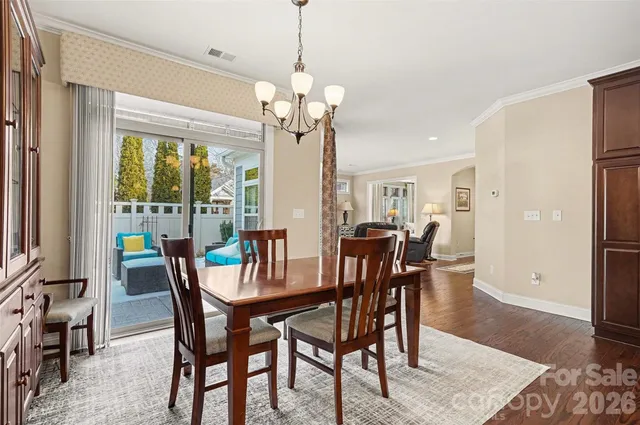 a kitchen with stainless steel appliances granite countertop a kitchen island a stove a table and chairs