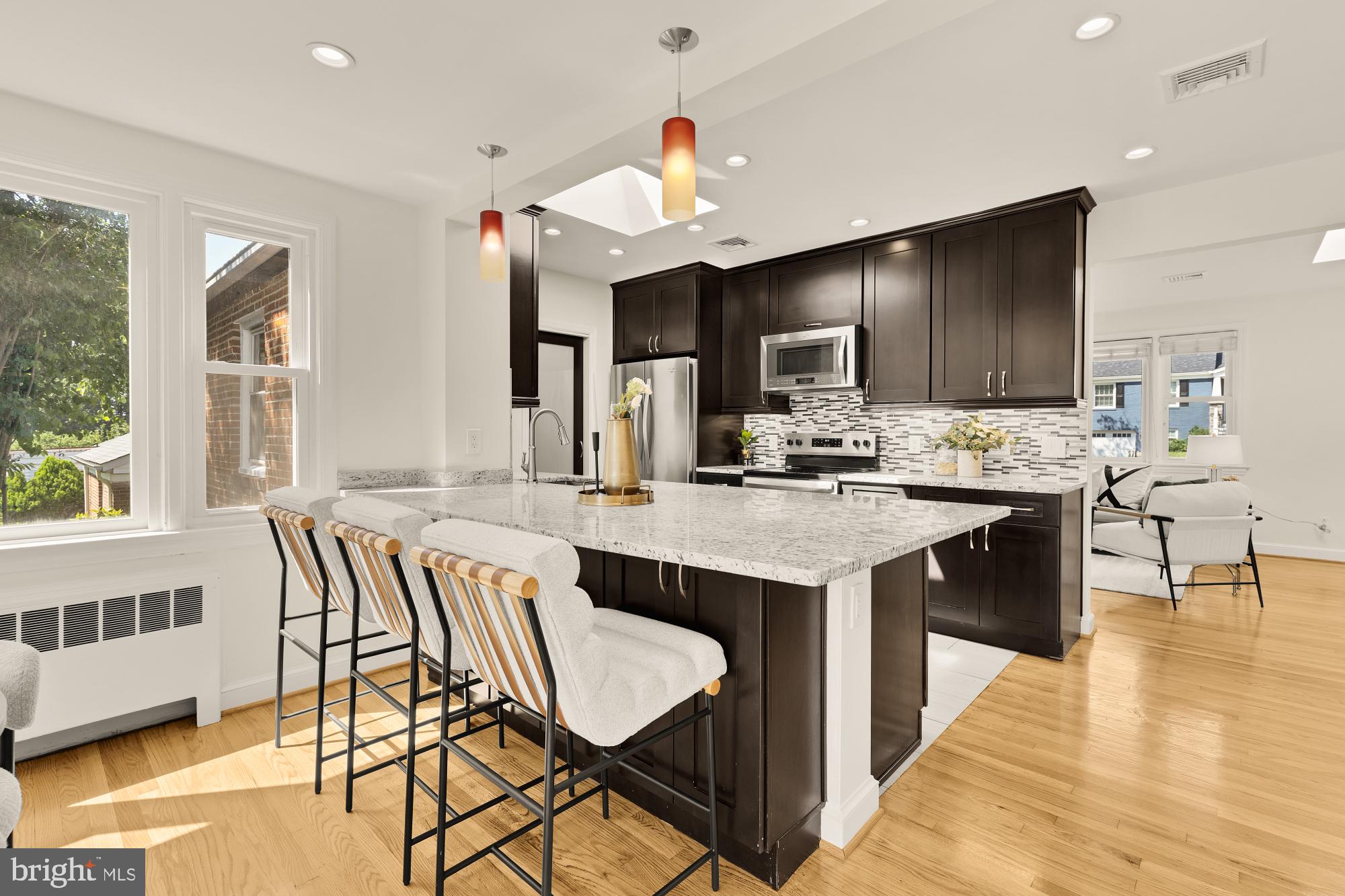 8921 Whitney Street Silver Spring, MD 20901 - Photo 11 of 27 a kitchen with a table chairs stove and kitchen view
