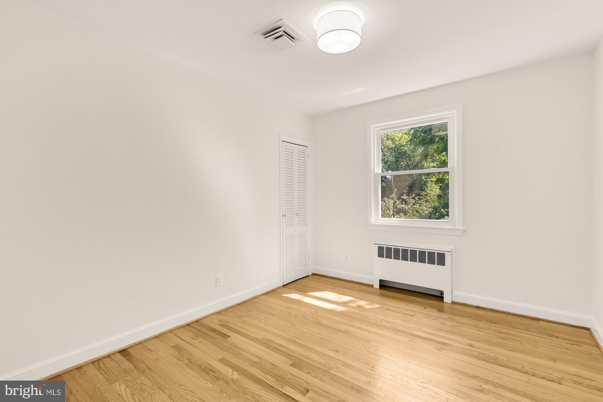 8921 Whitney Street Silver Spring, MD 20901 - Photo 16 of 27 an empty room with wooden floor and windows