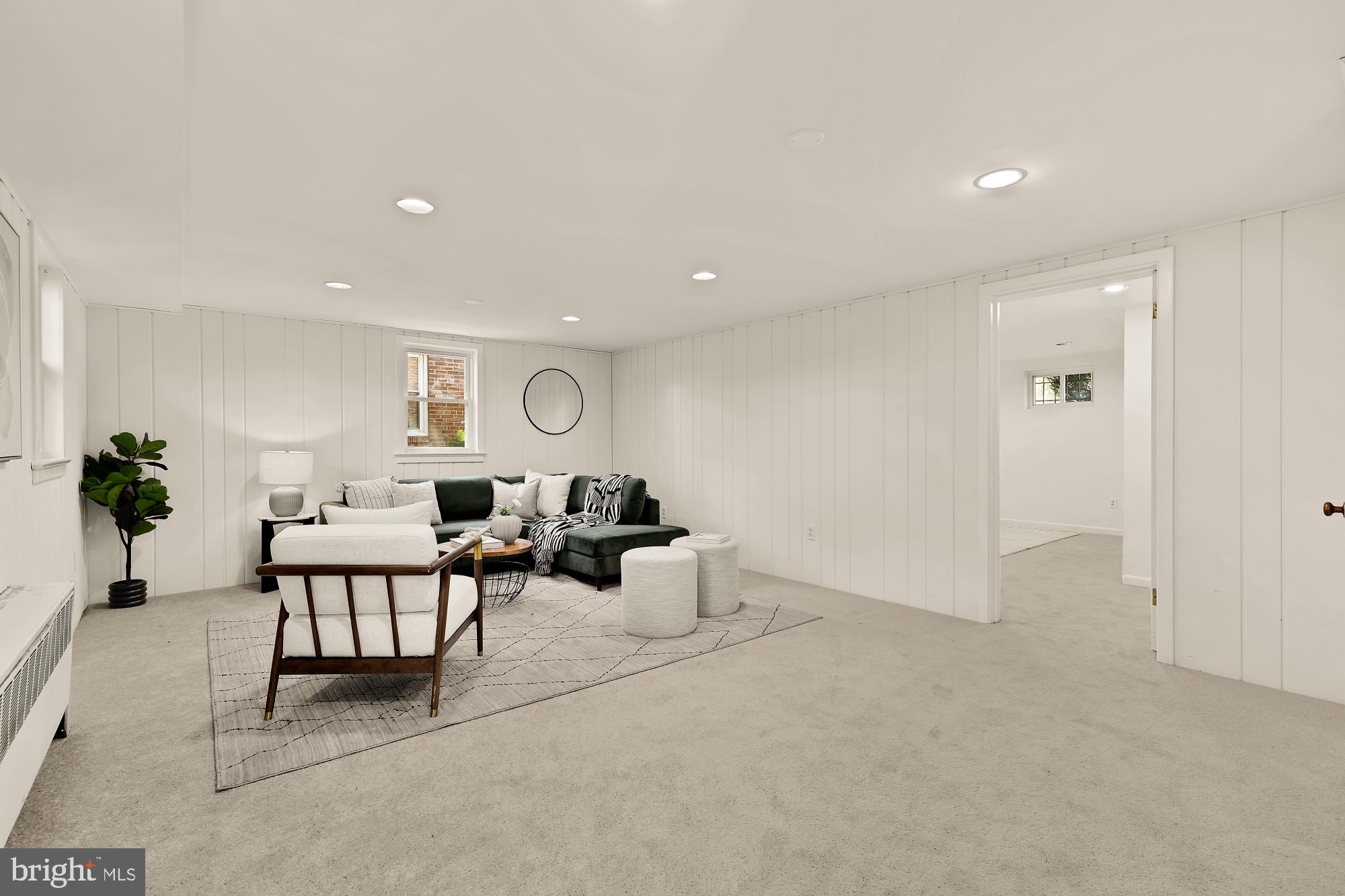 8921 Whitney Street Silver Spring, MD 20901 - Photo 21 of 27 a living room with furniture and a potted plant