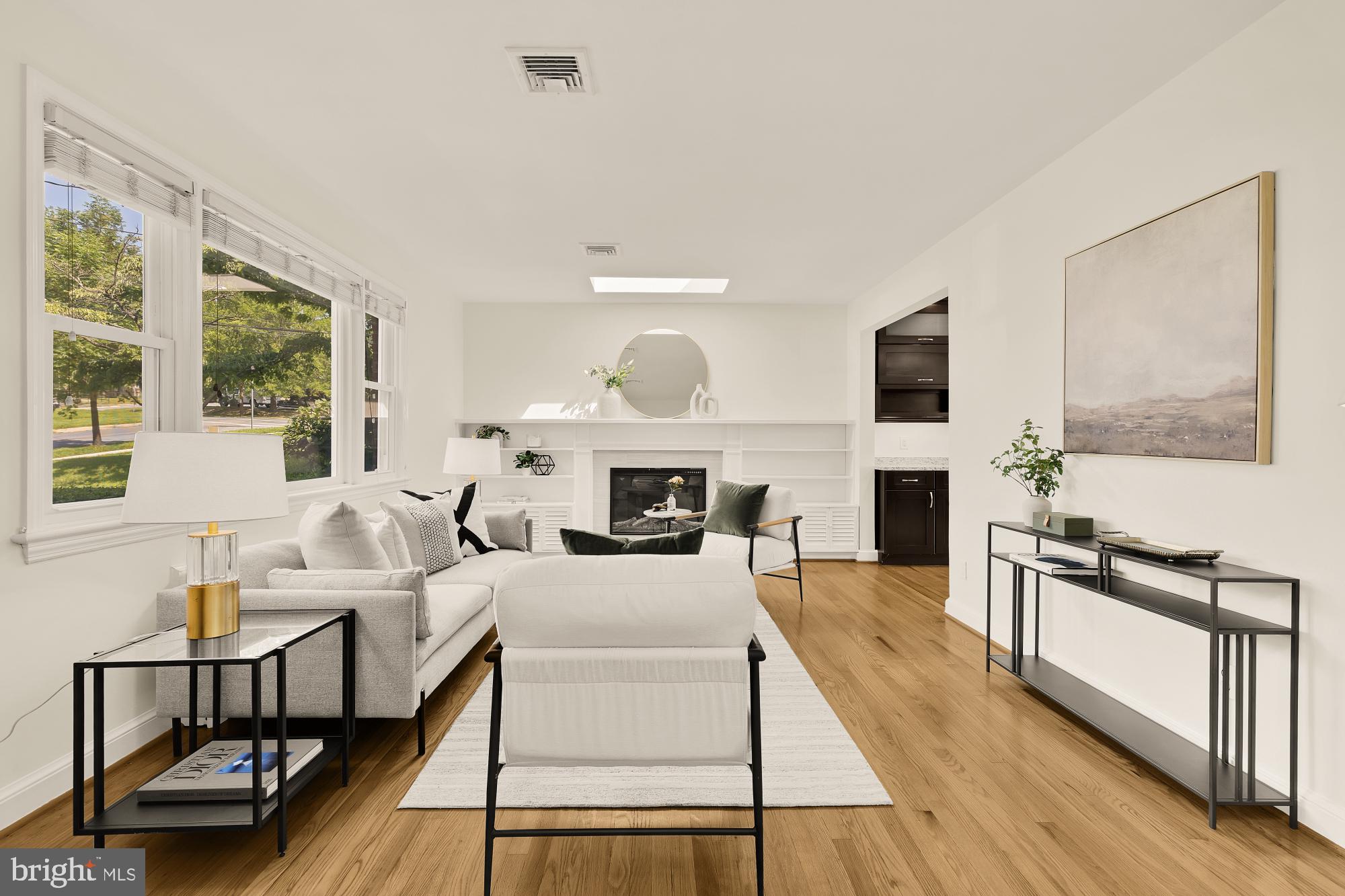 8921 Whitney Street Silver Spring, MD 20901 - Photo 3 of 27 a living room with furniture a fireplace and a flat screen tv