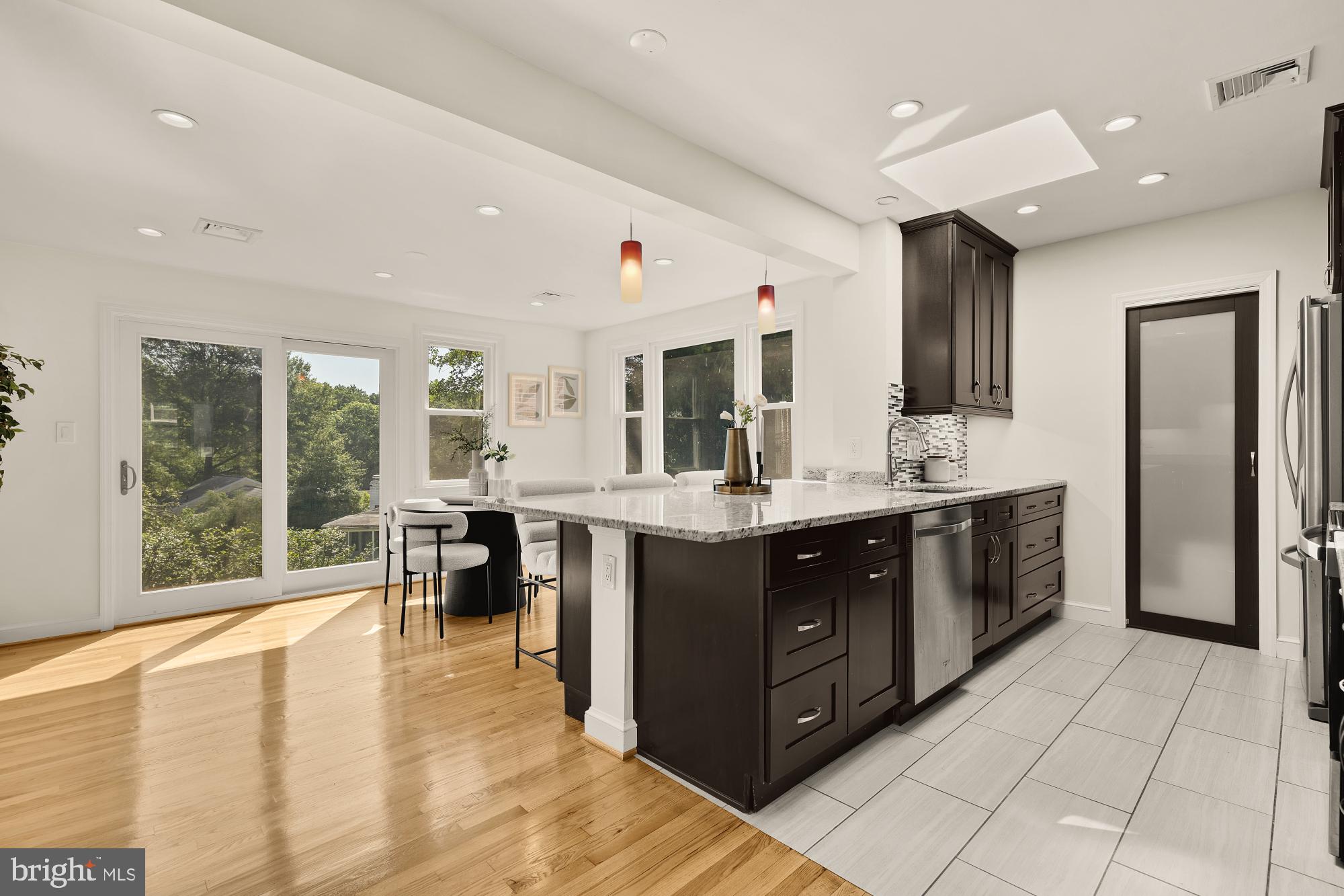 8921 Whitney Street Silver Spring, MD 20901 - Photo 7 of 27 a kitchen with a sink counter top space and stainless steel appliances