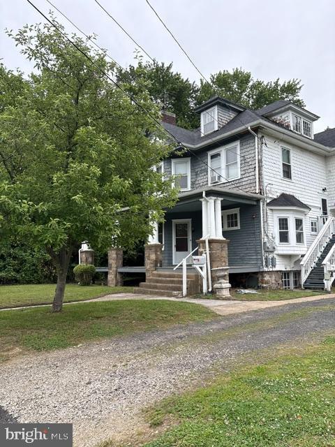 718 Woodlane Road Beverly, NJ 08010 - Photo 5 of 22 a front view of a house with a yard