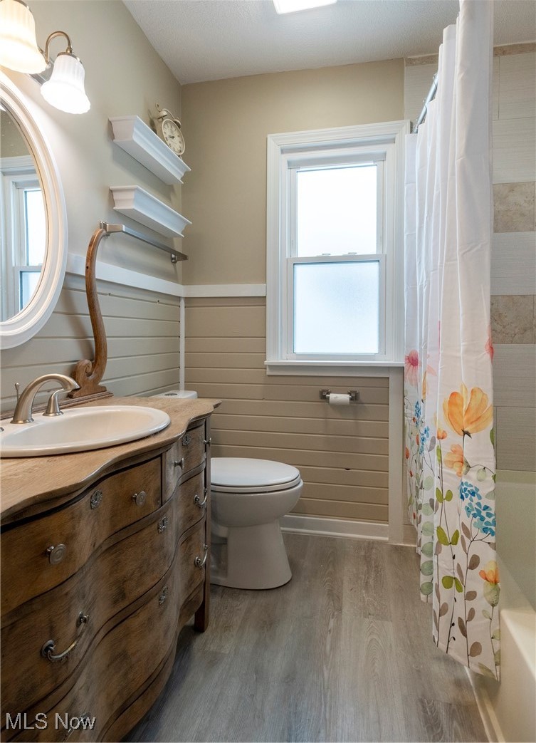 767 Glenhurst Road Willowick, OH 44095 - Photo 11 of 42 Full bathroom with toilet, vanity, shower / bath combo, and hardwood / wood-style floors