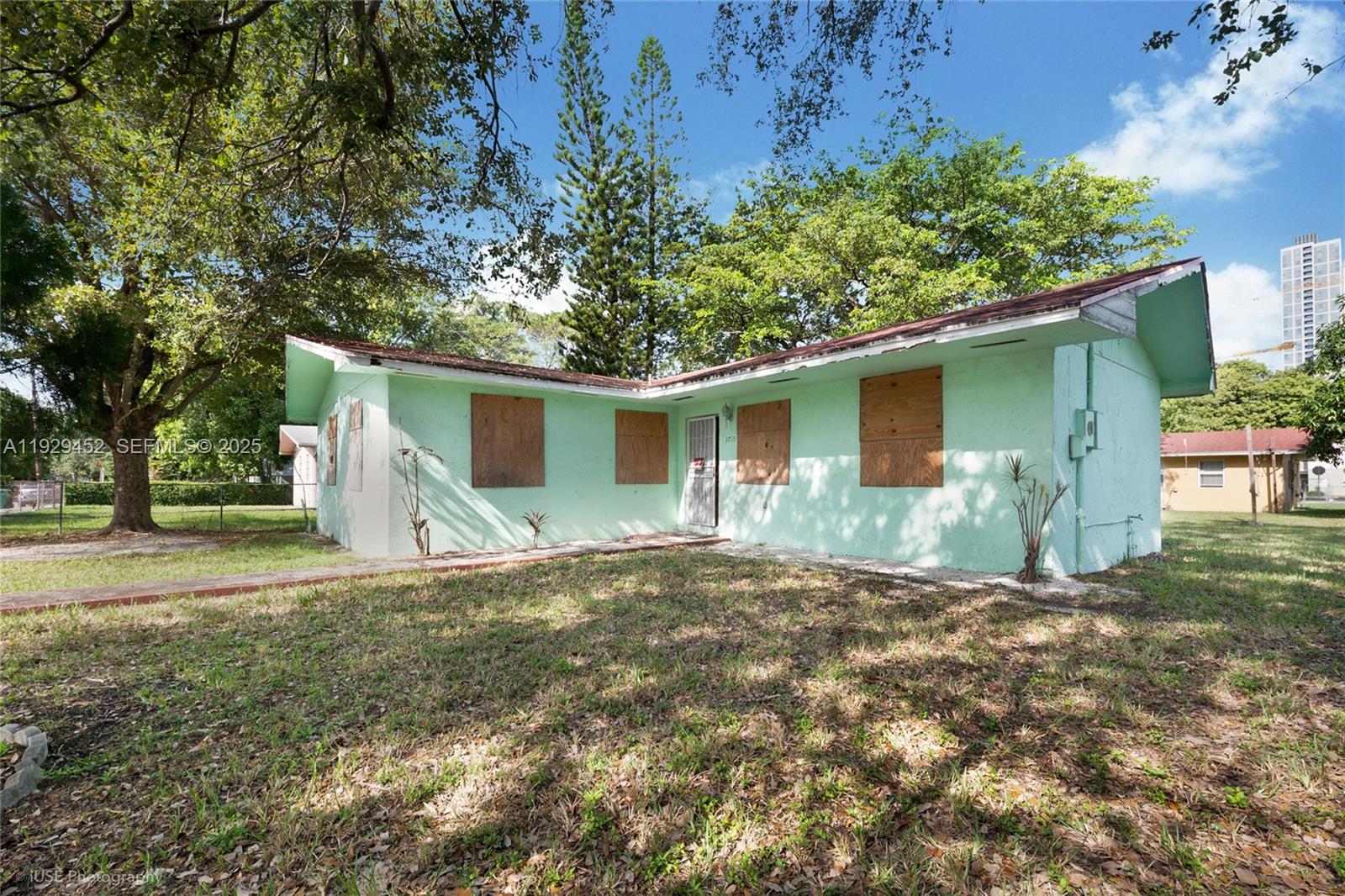 3715 Oak Avenue Miami, FL 33133 - Photo 15 of 26 a view of a house with a yard and large tree