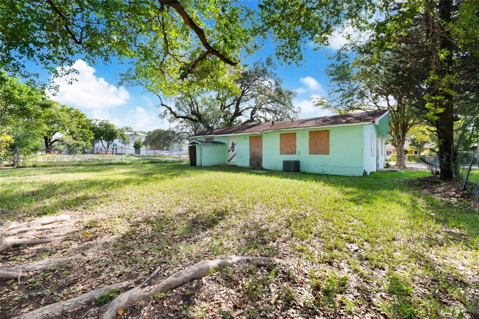 3715 Oak Avenue Miami, FL 33133 - Photo 17 of 26 a front view of house with yard and trees