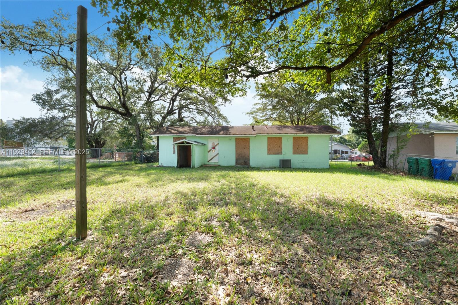 3715 Oak Avenue Miami, FL 33133 - Photo 19 of 26 a front view of house with yard and tree