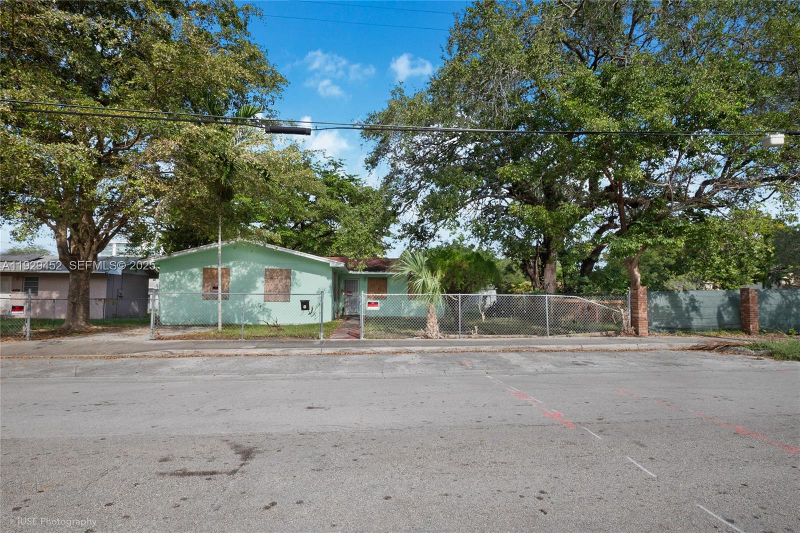 3715 Oak Avenue Miami, FL 33133 - Photo 8 of 26 a front view of a house with a yard and large trees