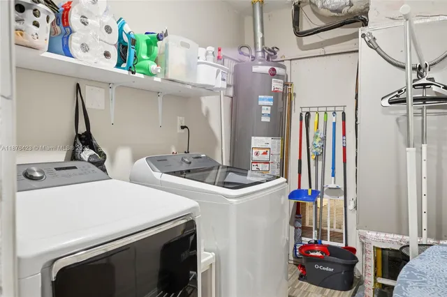 a view of storage and utility room with two washing machine