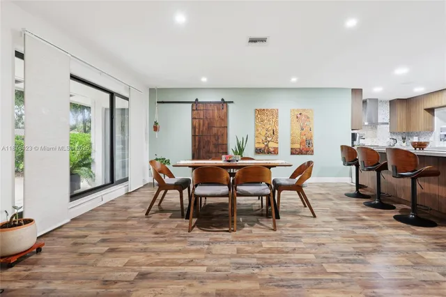 a view of a a dining room with furniture window and outside view