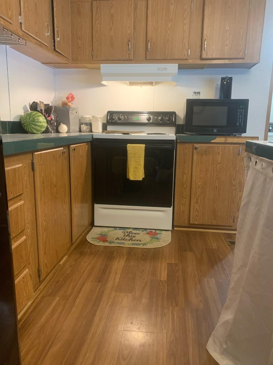 1073 Friendship Road Shawsville, VA 24162 - Photo 6 of 11 a kitchen with stainless steel appliances granite countertop a stove a sink and a refrigerator
