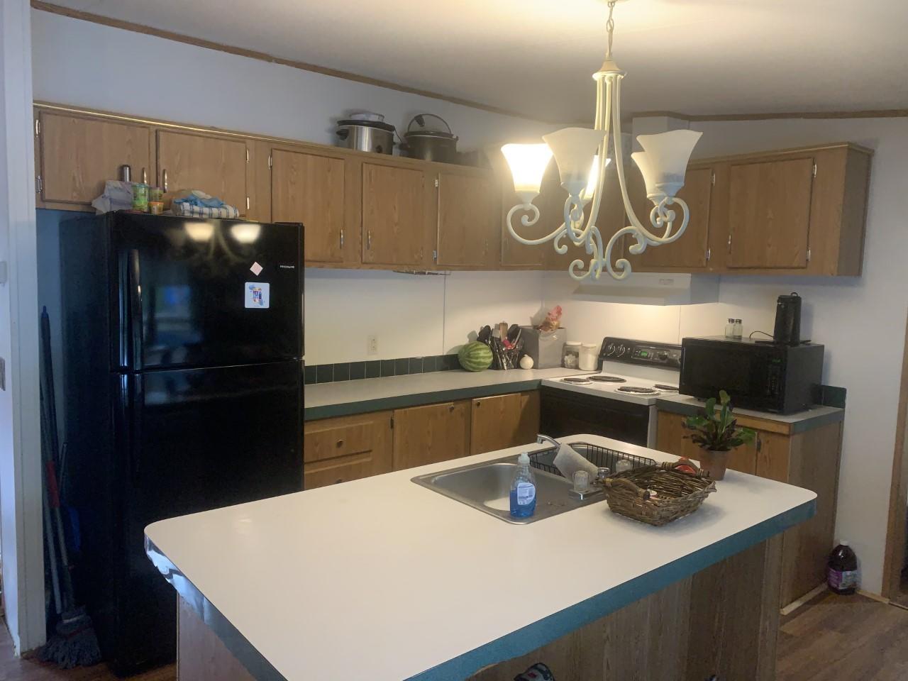 1073 Friendship Road Shawsville, VA 24162 - Photo 7 of 11 a kitchen with a sink a refrigerator and cabinets