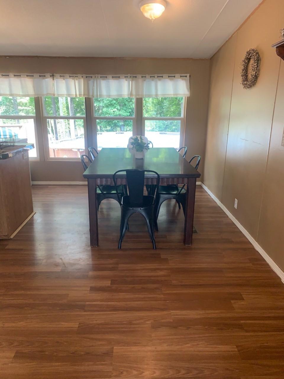 1073 Friendship Road Shawsville, VA 24162 - Photo 8 of 11 a view of a dining room with furniture window and wooden floor