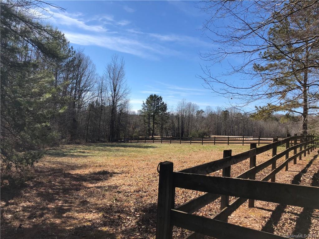 999 Collinsville Road Columbus, NC 28722 - Photo 1 of 16 a view of a lake with a bench