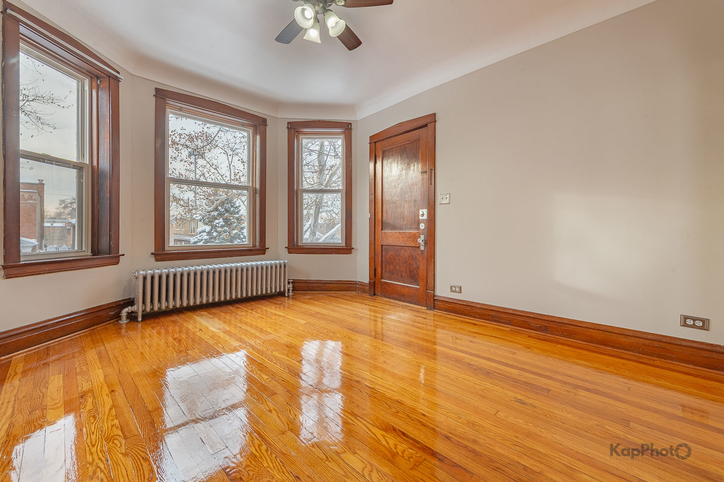 3530 West Evergreen Avenue, Unit 2 Chicago, IL 60651 - Photo 6 of 25 a view of an empty room with a window and wooden floor