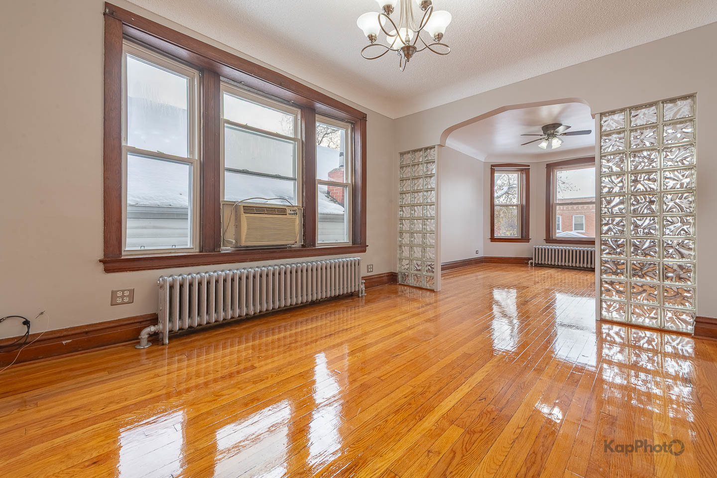 3530 West Evergreen Avenue, Unit 2 Chicago, IL 60651 - Photo 8 of 25 an empty room with wooden floor and windows