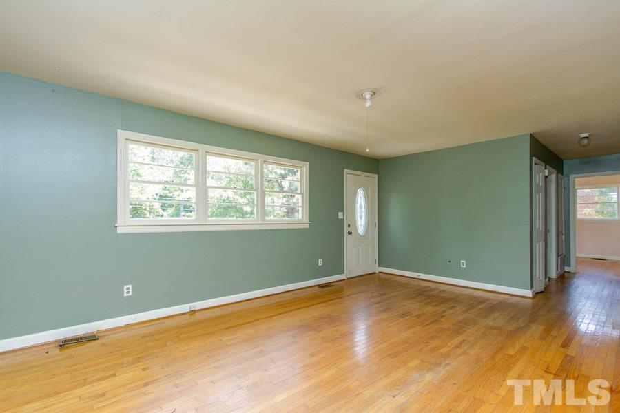3832 Corwin Road Garner, NC 27529 - Photo 13 of 21 an empty room with wooden floor and windows