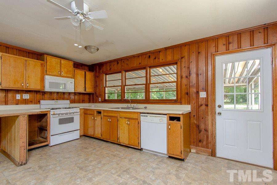 3832 Corwin Road Garner, NC 27529 - Photo 16 of 21 a kitchen with stainless steel appliances granite countertop stove a sink dishwasher and a refrigerator