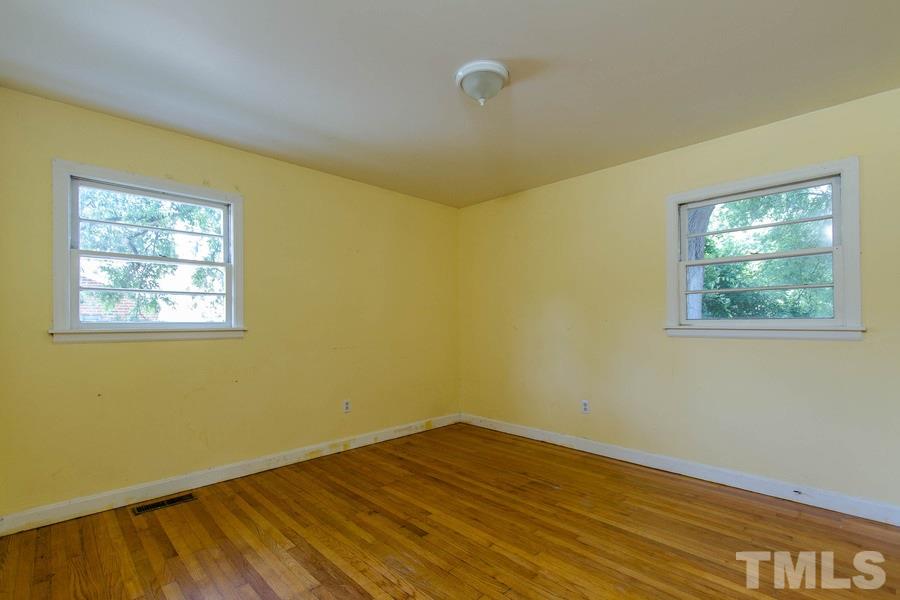 3832 Corwin Road Garner, NC 27529 - Photo 19 of 21 a view of an empty room with wooden floor and a window