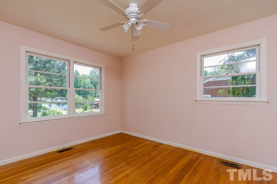 3832 Corwin Road Garner, NC 27529 - Photo 20 of 21 a view of an empty room with wooden floor and a window