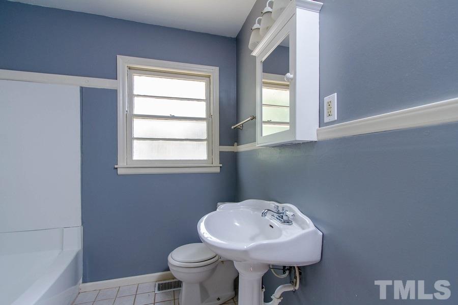 3832 Corwin Road Garner, NC 27529 - Photo 21 of 21 a bathroom with a sink a toilet and a window
