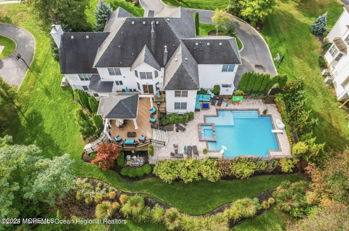 an aerial view of a house with a garden and lake view