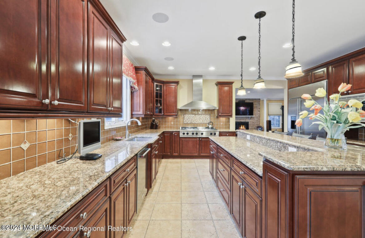 29 Northwoods Road Asbury Park, NJ 07712 - Photo 13 of 34 a kitchen with stainless steel appliances granite countertop a sink a stove and a wooden floors