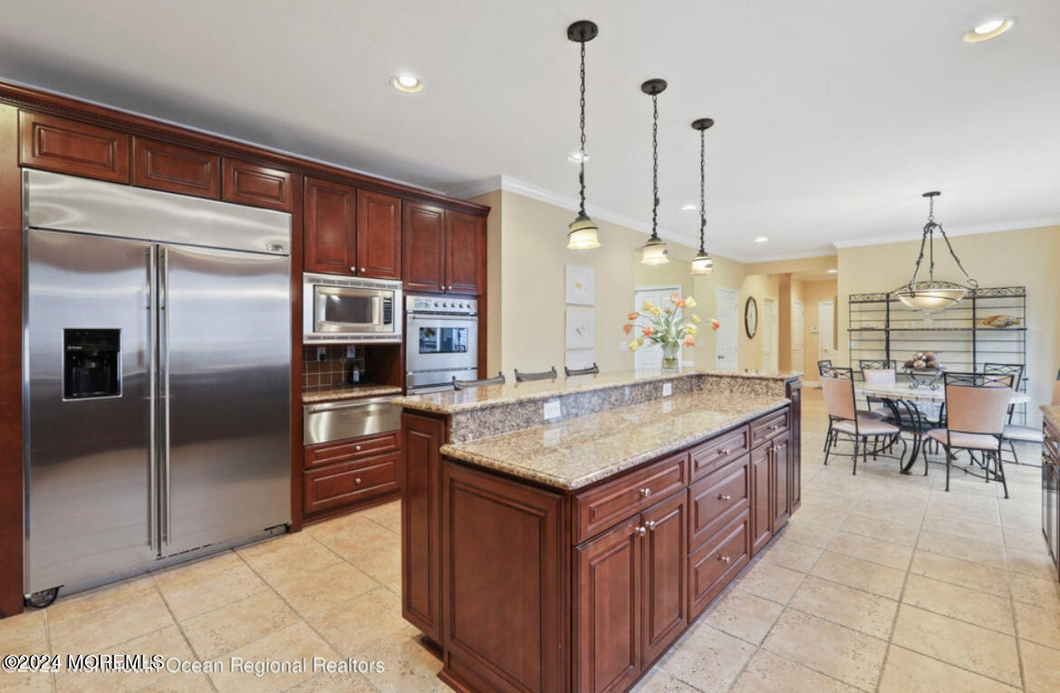 29 Northwoods Road Asbury Park, NJ 07712 - Photo 14 of 34 a kitchen with kitchen island granite countertop a island a counter top space appliances and cabinets