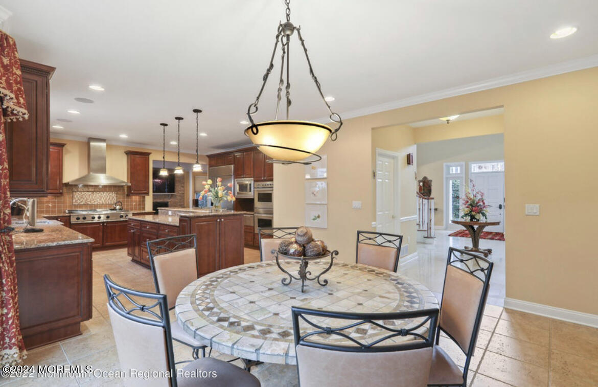 29 Northwoods Road Asbury Park, NJ 07712 - Photo 15 of 34 a dining room with a table and chairs