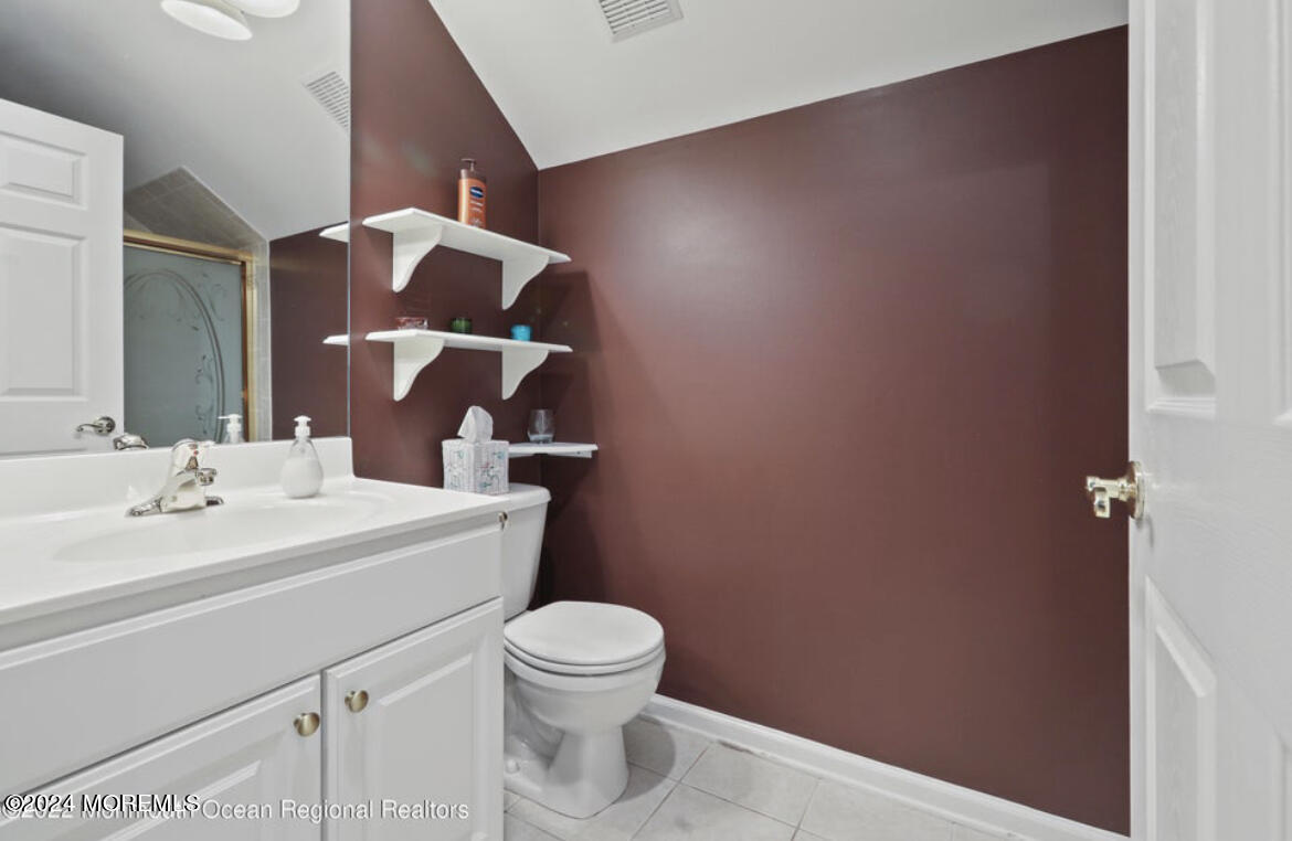 29 Northwoods Road Asbury Park, NJ 07712 - Photo 18 of 34 a bathroom with a toilet a sink and mirror