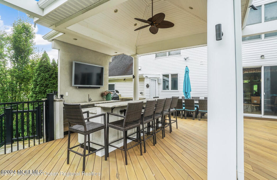 29 Northwoods Road Asbury Park, NJ 07712 - Photo 2 of 34 a view of a dining room and kitchen with furniture wooden floor and a chandelier