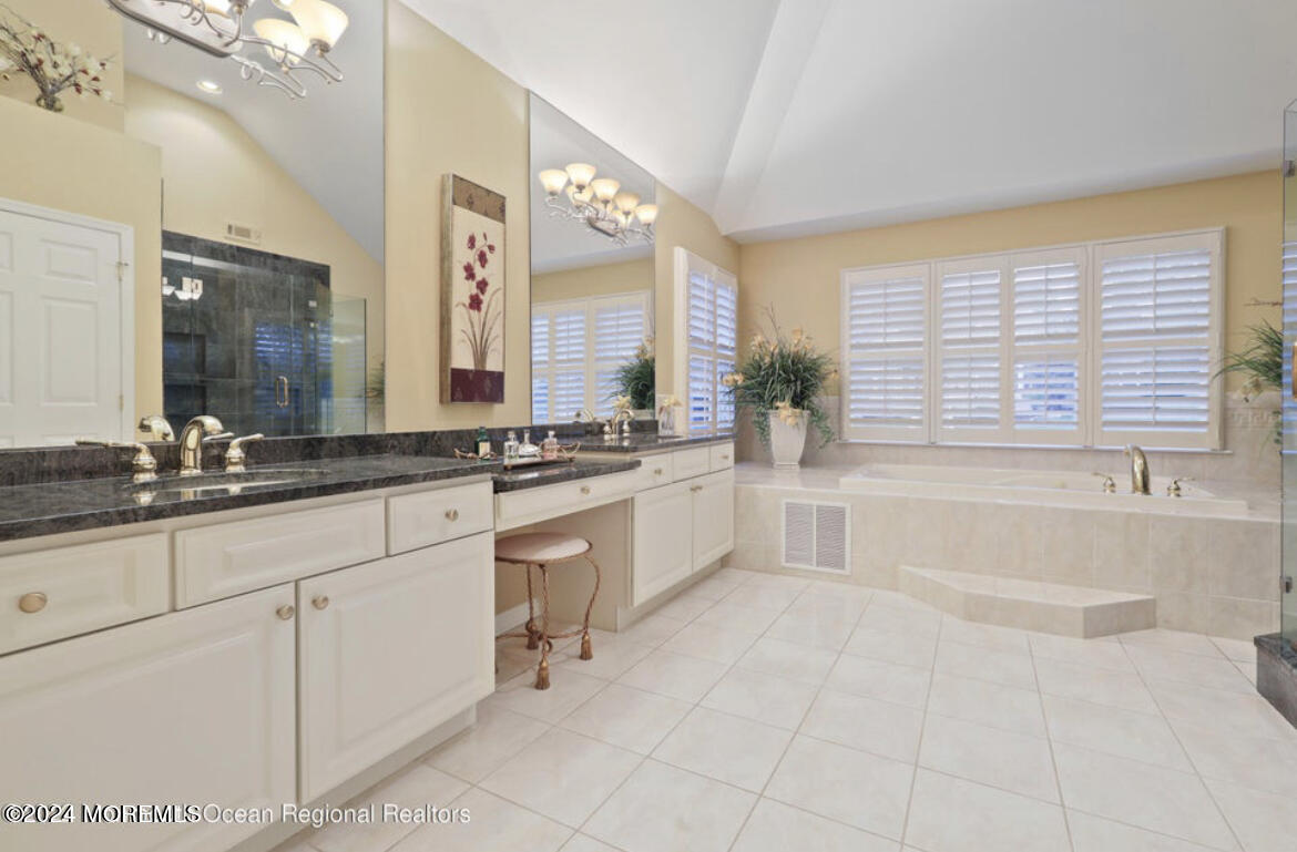 29 Northwoods Road Asbury Park, NJ 07712 - Photo 22 of 34 a bathroom with a sink vanity tub and a mirror